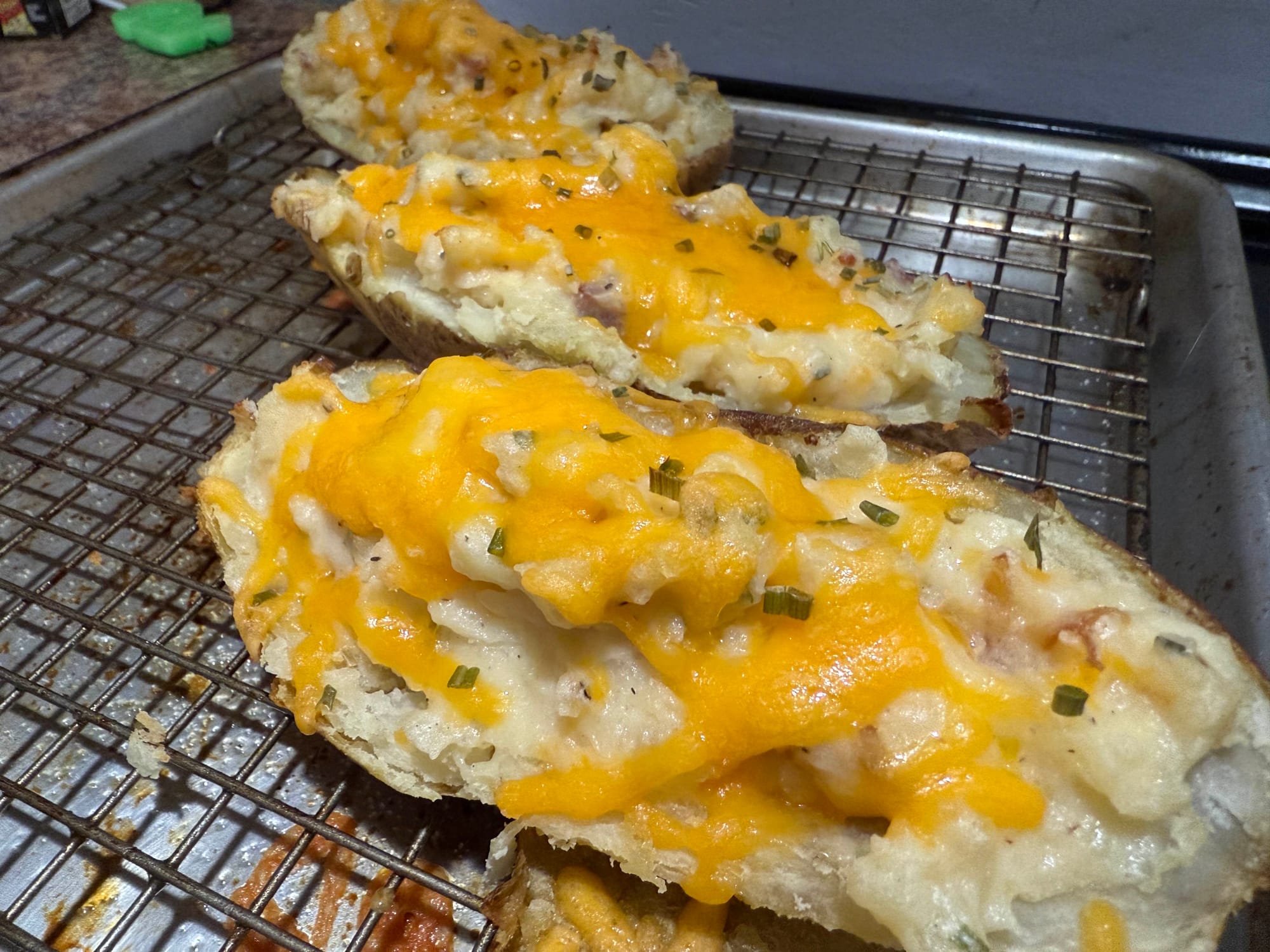A sheet pan loaded with twice-baked potatoes.