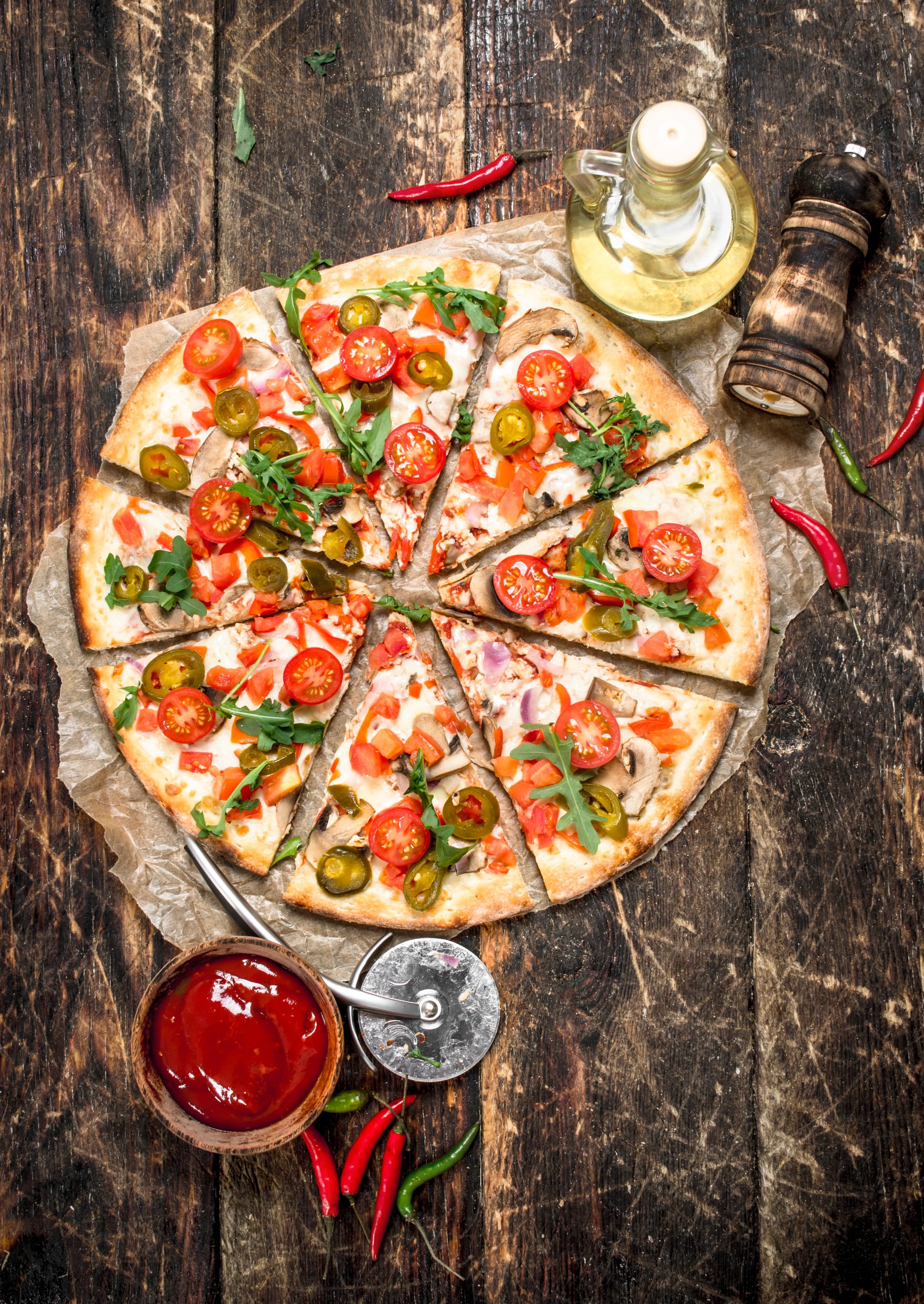 fresh pizza with tomatoes and greens.