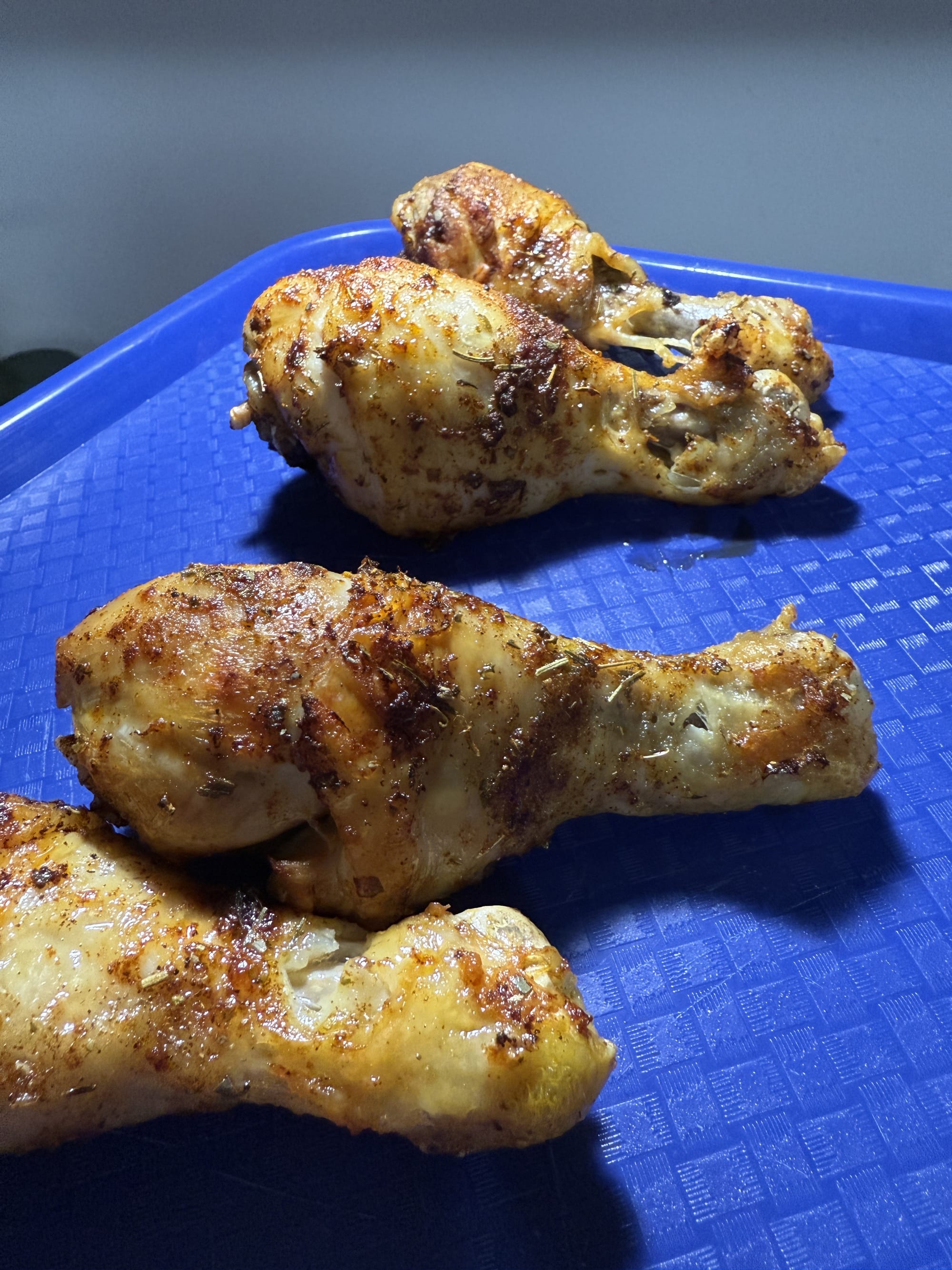 A tray full of twice-fried chicken drumsticks.